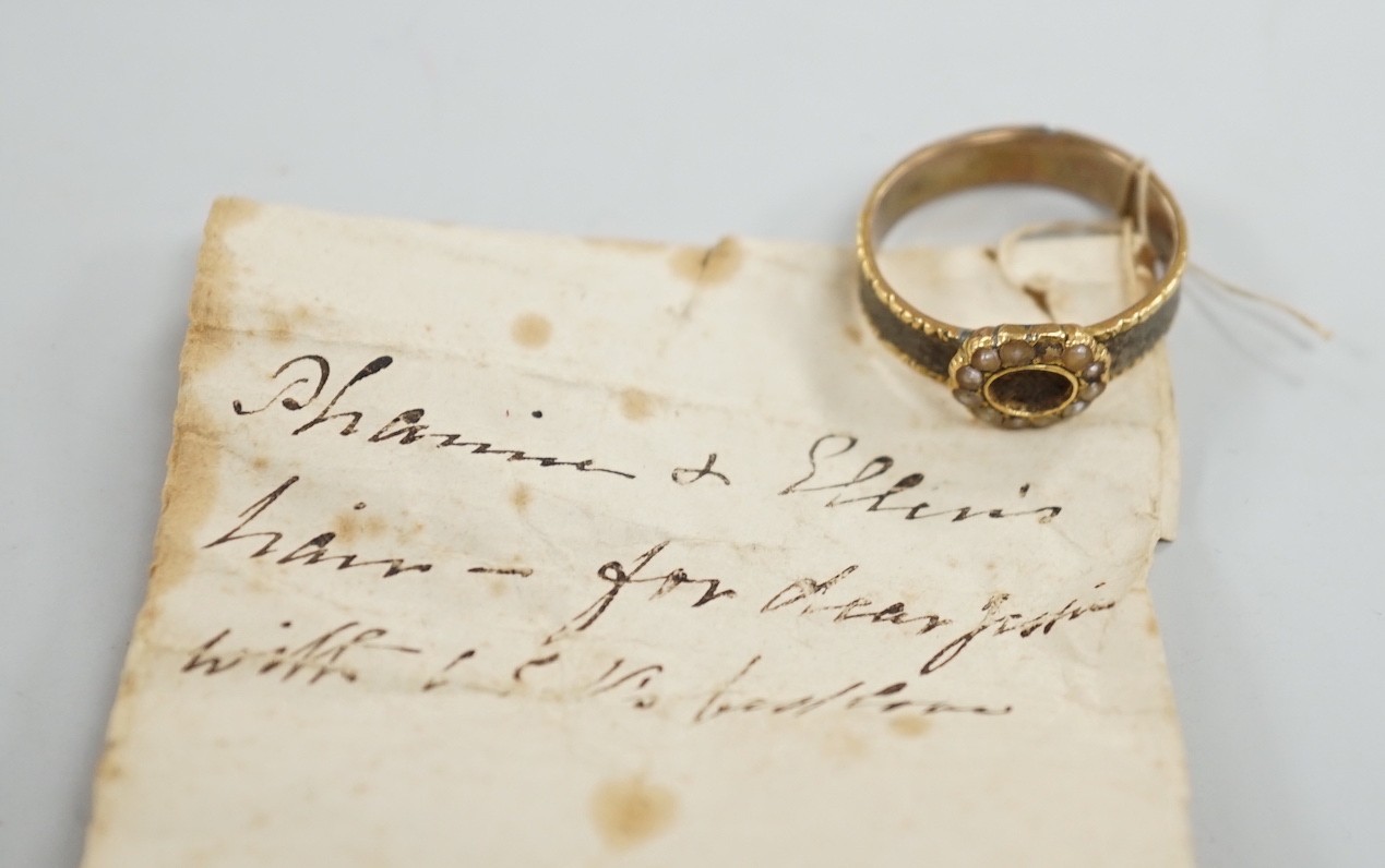 A 19th century yellow metal, split pearl and plaited hair set mourning ring, size O, gross weight 2.9 grams.
